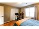 Bedroom featuring wood floors, a peloton bike, natural light, a ceiling fan, and a closet at 3874 Carriage Sw Ln, Conyers, GA 30094