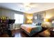 Bedroom featuring wood floors, a ceiling fan, a peloton bike, and an abundance of natural light at 3874 Carriage Sw Ln, Conyers, GA 30094