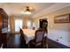 Charming dining room with hardwood floors, ample natural light, and stylish furnishings at 3874 Carriage Sw Ln, Conyers, GA 30094
