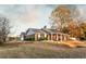 Beautiful single-story home with a well-manicured lawn, attached garage, and brick exterior at 3874 Carriage Sw Ln, Conyers, GA 30094