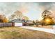 View of the garage and driveway of a cozy home featuring brick and gray siding at 3874 Carriage Sw Ln, Conyers, GA 30094
