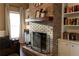 Close-up of a charming brick fireplace with mantel decor and built-in bookshelves at 3874 Carriage Sw Ln, Conyers, GA 30094