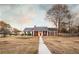 Charming brick home featuring a red front door, black shutters and inviting front porch at 3874 Carriage Sw Ln, Conyers, GA 30094