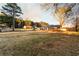 Traditional home with a spacious front yard and mature trees at 3874 Carriage Sw Ln, Conyers, GA 30094