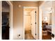 Hallway leading to a bedroom and a bathroom, with neutral walls and wood flooring at 3874 Carriage Sw Ln, Conyers, GA 30094