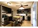 Cozy kitchen features black cabinets, stainless steel appliances, and a functional butcher block island at 3874 Carriage Sw Ln, Conyers, GA 30094