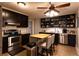 Kitchen showcasing black cabinetry, stainless steel appliances, butcher block island, and tile flooring at 3874 Carriage Sw Ln, Conyers, GA 30094
