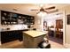 Charming kitchen with black cabinets, butcher block island, and an open layout to the dining room at 3874 Carriage Sw Ln, Conyers, GA 30094