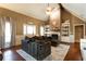 Spacious living room with a brick fireplace, built-in bookshelves, and hardwood floors at 3874 Carriage Sw Ln, Conyers, GA 30094