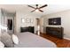 Bright main bedroom boasts hardwood floors, neutral walls, and a wall-mounted television at 3874 Carriage Sw Ln, Conyers, GA 30094