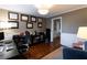 Office featuring wood floors, decorative wall art, desk space, and comfortable seating at 3874 Carriage Sw Ln, Conyers, GA 30094
