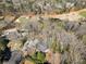 Wide aerial view of the brick home and the surrounding neighborhood, golf course, and lake area at 812 Burning Tree Se Ct, Marietta, GA 30067