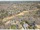 Aerial view of a luxury home in a wooded neighborhood near a golf course at 812 Burning Tree Se Ct, Marietta, GA 30067