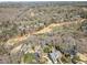 Bird's-eye view of a neighborhood bordering a golf course, showcasing mature trees and well-spaced residences at 812 Burning Tree Se Ct, Marietta, GA 30067