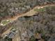 Expansive aerial view of the property with mature trees, a golf course, and a pond at 812 Burning Tree Se Ct, Marietta, GA 30067
