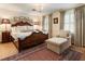 Elegant bedroom with a wooden bed frame, chandelier, and neutral color scheme at 812 Burning Tree Se Ct, Marietta, GA 30067