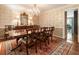 Elegant dining room with a crystal chandelier, decorative wallpaper, and hardwood floors at 812 Burning Tree Se Ct, Marietta, GA 30067