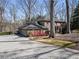 A beautifully landscaped brick home featuring a paved driveway and an attached two-car garage at 812 Burning Tree Se Ct, Marietta, GA 30067