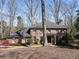 Traditional brick home with lush landscaping, mature tree coverage, and a classic design at 812 Burning Tree Se Ct, Marietta, GA 30067