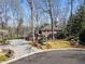Charming exterior view of a brick home with a circular driveway and beautifully landscaped front yard at 812 Burning Tree Se Ct, Marietta, GA 30067