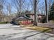 Brick home with a three-car garage and circular driveway, set amidst beautifully landscaped grounds and mature trees at 812 Burning Tree Se Ct, Marietta, GA 30067