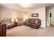 Comfortable living room features carpet, two upholstered armchairs, and a brown sofa at 812 Burning Tree Se Ct, Marietta, GA 30067