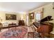Elegant living room with a grand piano, traditional furnishings, and hardwood floors at 812 Burning Tree Se Ct, Marietta, GA 30067