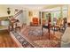 Well-appointed living room featuring a piano, patterned rug, and classic furnishings at 812 Burning Tree Se Ct, Marietta, GA 30067