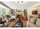 Inviting living room featuring a brick fireplace and ample natural light from the large windows at 812 Burning Tree Se Ct, Marietta, GA 30067