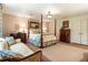 Spacious main bedroom with a four-poster bed, sitting area, and neutral decor at 812 Burning Tree Se Ct, Marietta, GA 30067