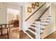 Classic staircase with wood steps, white spindles, and access to a dining room at 812 Burning Tree Se Ct, Marietta, GA 30067