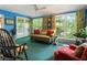 Serene sunroom with multiple windows, plush seating, and views of the outdoors at 812 Burning Tree Se Ct, Marietta, GA 30067
