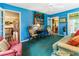Bright sunroom with blue walls, large windows, and a cozy seating area at 812 Burning Tree Se Ct, Marietta, GA 30067