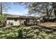 Wide backyard view featuring deck, brick house, and green lawn at 3427 Springlake Dr, Decatur, GA 30032