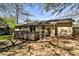 Home exterior with backyard deck, lush greenery, and trees at 3427 Springlake Dr, Decatur, GA 30032