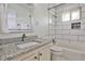 Updated bathroom with granite countertop, white tiled walls, and modern fixtures at 3427 Springlake Dr, Decatur, GA 30032