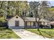 Charming single-story home with a well-manicured lawn, a covered front porch, and mature trees at 3427 Springlake Dr, Decatur, GA 30032