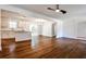 View of the hardwood floors that flow into the white kitchen with granite countertop island at 3427 Springlake Dr, Decatur, GA 30032