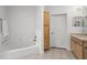 Bathroom featuring a soaking tub, vanity with storage, and neutral decor at 799 Hammond Dr # 205, Sandy Springs, GA 30328