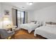 Cozy bedroom with two beds, wood floors, and natural light at 799 Hammond Dr # 205, Sandy Springs, GA 30328