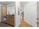 Hallway view from kitchen leading to open and airy living space, bright natural light, and clean white walls at 799 Hammond Dr # 205, Sandy Springs, GA 30328