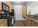 Kitchen featuring granite countertops, stainless steel appliances, and tile flooring at 799 Hammond Dr # 205, Sandy Springs, GA 30328