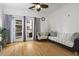 Comfortable living room offers hardwood floors, natural light from balcony, ceiling fan, and relaxing seating at 799 Hammond Dr # 205, Sandy Springs, GA 30328