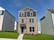 New two-story brick home featuring a modern design with gray accents and a well-manicured front lawn at 1352 Creekside Nw Cir, Atlanta, GA 30318