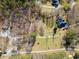 Aerial shot showcasing the property, surrounding landscape, and neighborhood homes in a rural area at 138 Rutledge Rd, Temple, GA 30179