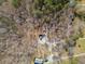 Overhead view of the house with a long driveway, surrounded by lush trees and natural landscape at 138 Rutledge Rd, Temple, GA 30179