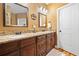 Bathroom features granite countertops, double sinks, with wooden cabinets and hardwood floors at 138 Rutledge Rd, Temple, GA 30179