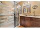 Bathroom featuring a glass enclosed shower with tiled walls, single sink vanity, and hardwood floors at 138 Rutledge Rd, Temple, GA 30179