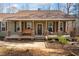 Charming front porch with stone accents on columns, a wooden porch swing, and a welcoming entrance at 138 Rutledge Rd, Temple, GA 30179
