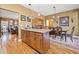 View of the kitchen island connecting the living room and dining room, with hardwood floors at 138 Rutledge Rd, Temple, GA 30179